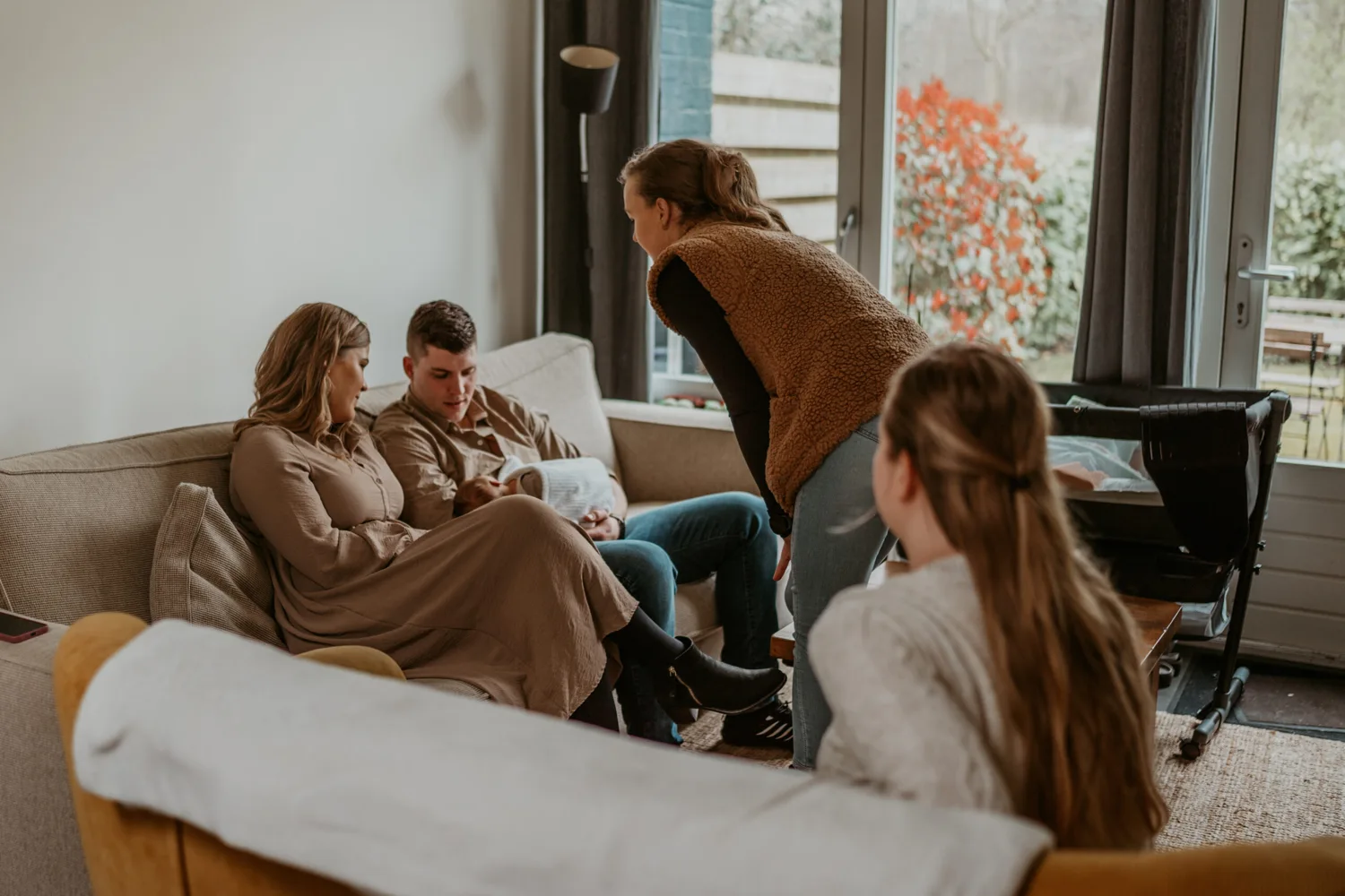 Een zwangere en haar partner in gesprek met verloskundigen van de praktijk